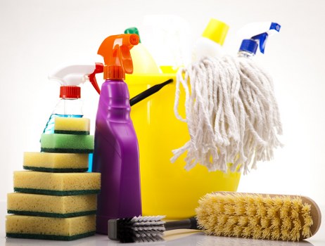 Cleaner working in a flat near Tooting with supplies